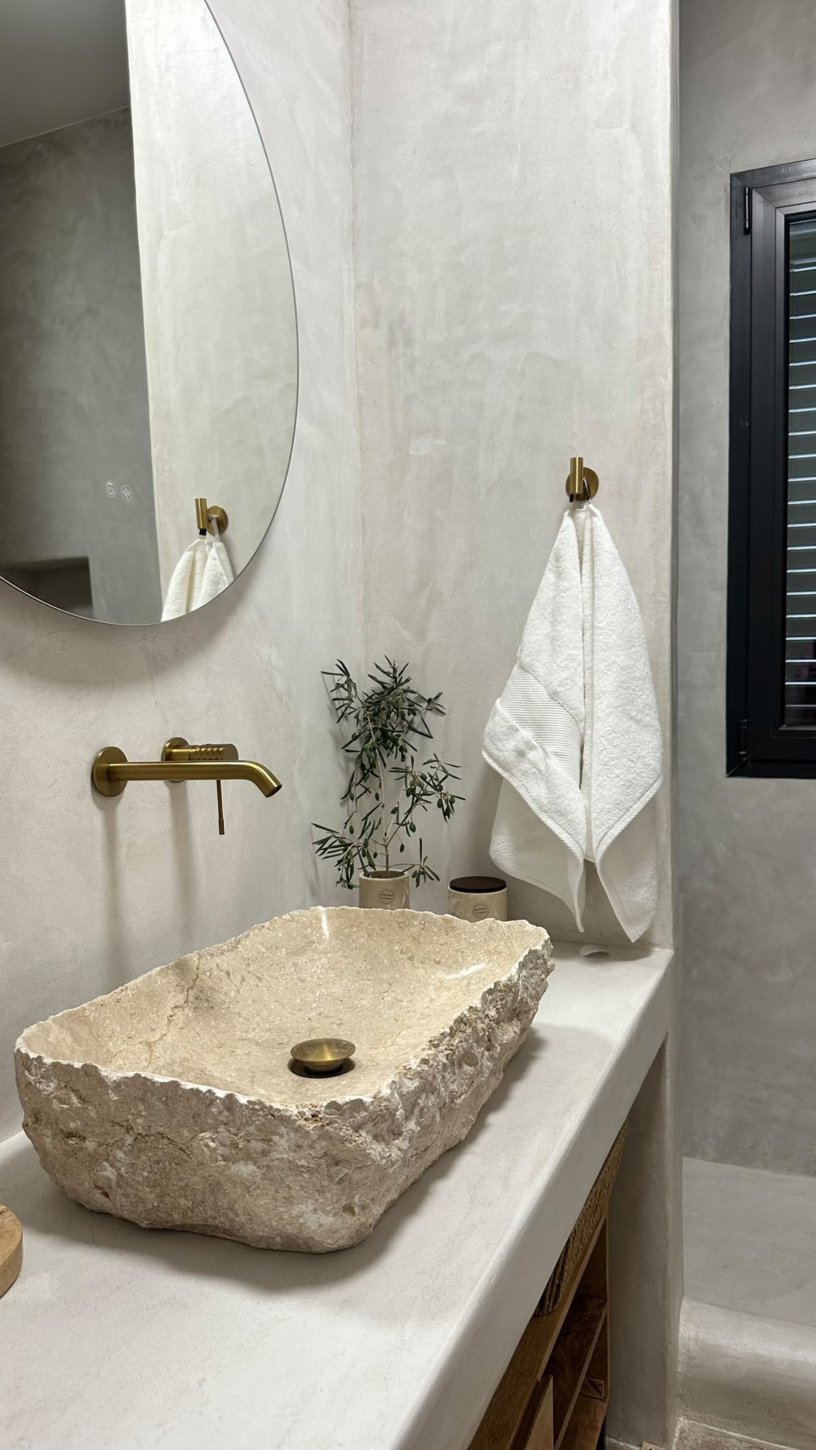 Stone sink, brass tap, olive sprig