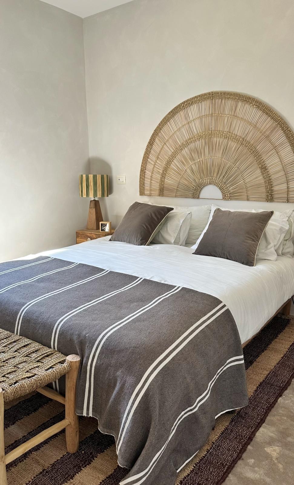 Bedroom with woven fan headboard