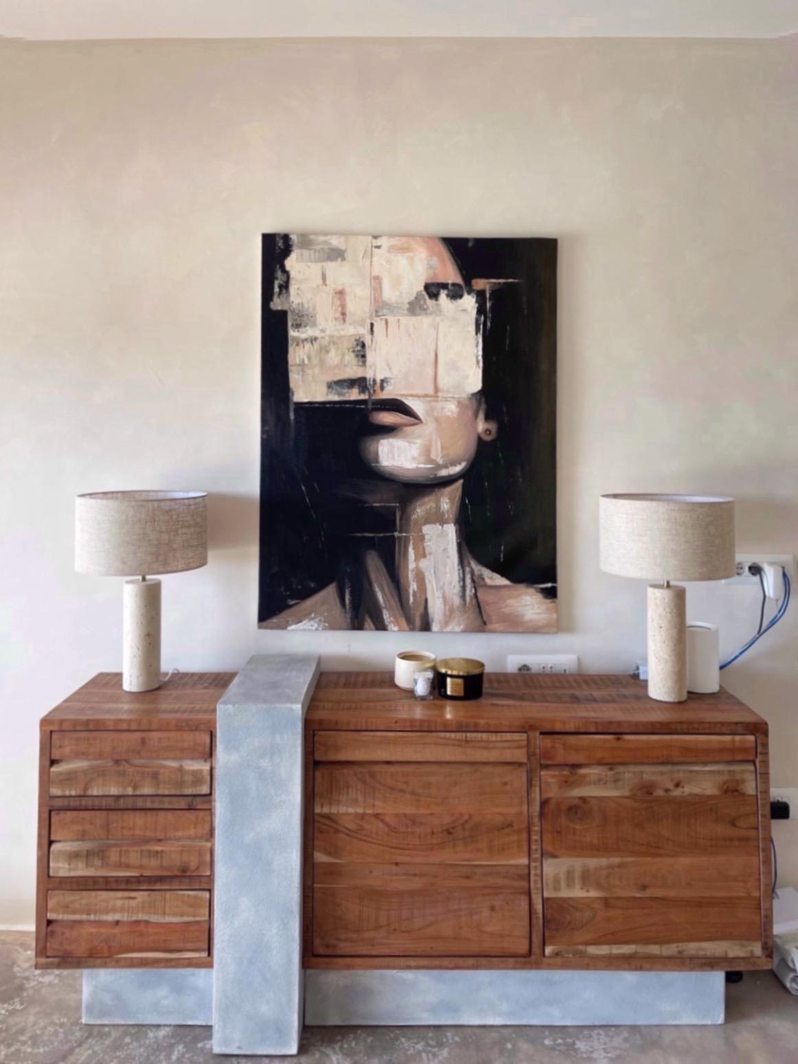 Entry console with portrait painting and travertine lamps