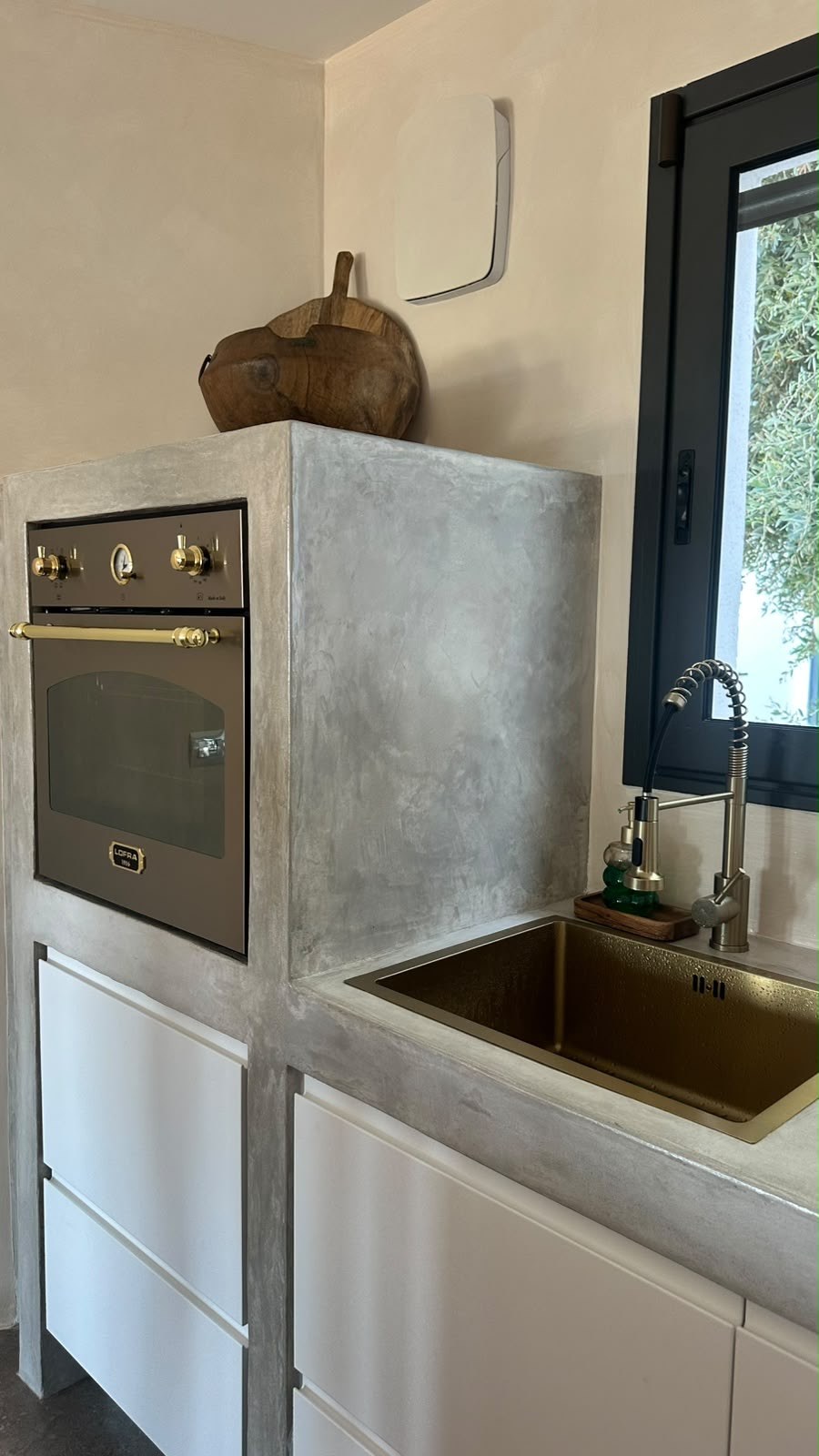 Brass kitchen sink under the window